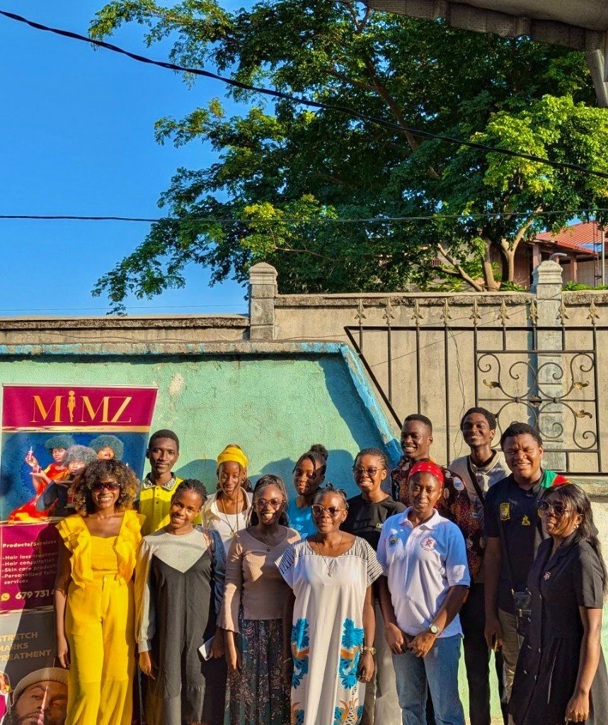 Group with MIMZ Luxury Beauty banner at outdoor community event